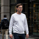 Young man walking on busy city street in casual outfit