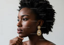 Elegant Black Woman with Luxury Pearl Earrings and Natural Makeup