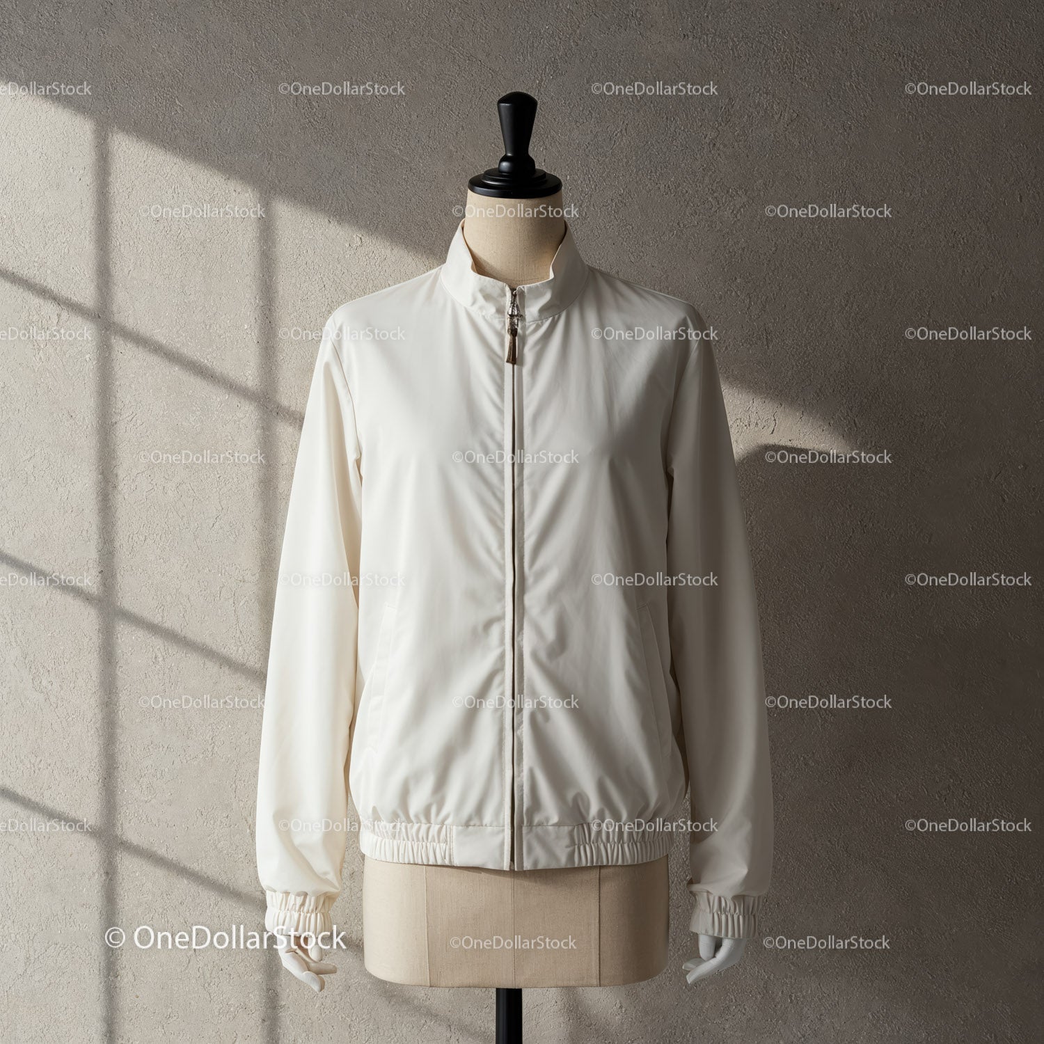 Minimalist white jacket on mannequin with soft lighting