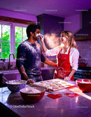 Couple Playfully Baking Heart Cookies Together