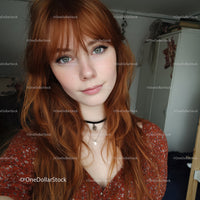 Young Woman with Red Hair and Blue Eyes in Cozy Indoor Setting