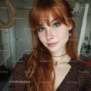 Young Woman with Red Hair and Blue Eyes in Casual Indoor Portrait