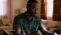 Thoughtful man reflecting quietly in warm living room