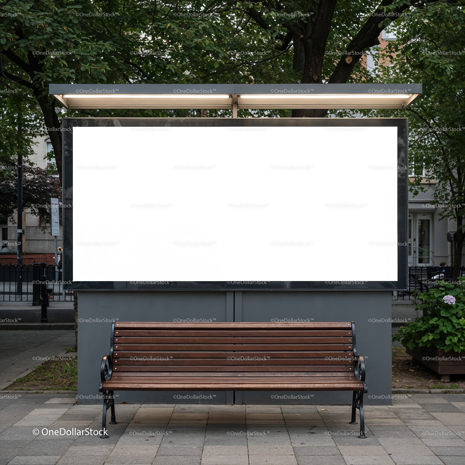Empty wooden bench in front of illuminated city billboard