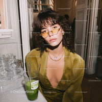 Stylish Woman with Yellow Sunglasses and Deep Neckline in Modern Interior