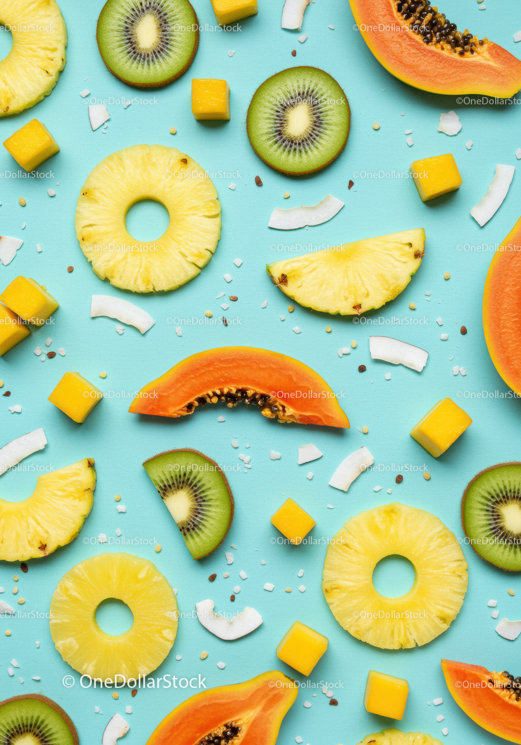 Fresh tropical fruit slices scattered on blue background