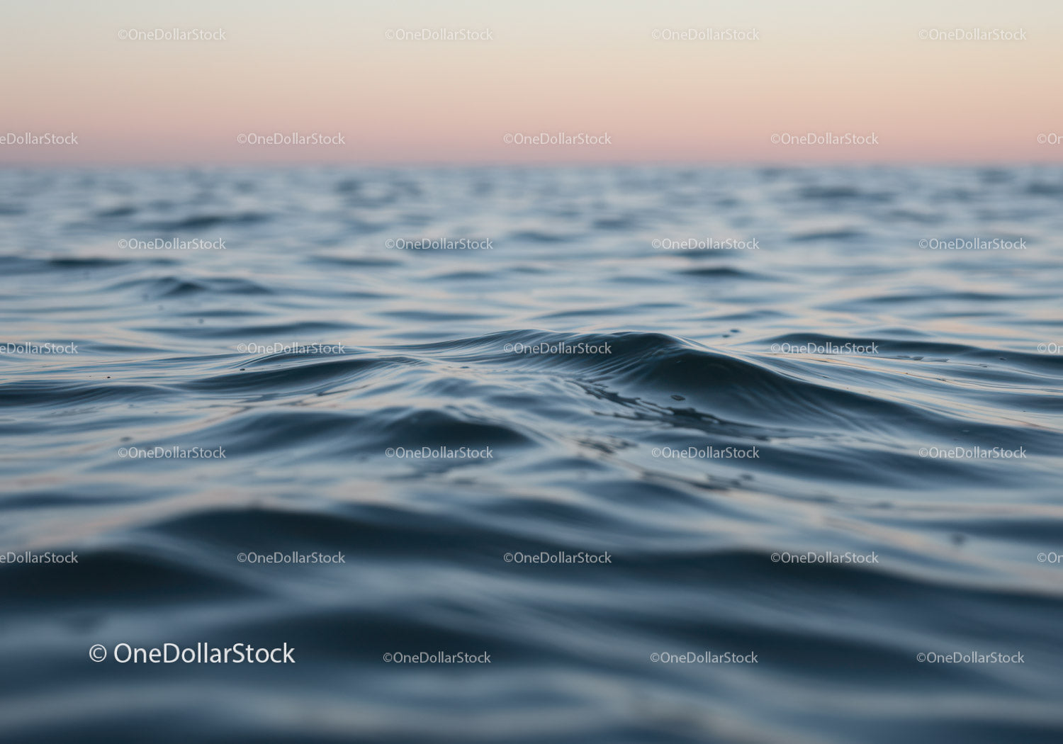 Calm Ocean Water Surface with Gentle Waves at Sunset
