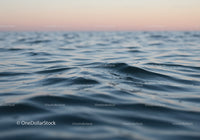 Calm Ocean Water Surface with Gentle Waves at Sunset