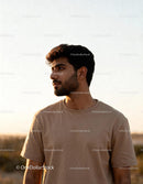 Thoughtful young man enjoying warm golden hour light