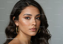 Portrait of a Stylish Woman with Wavy Hair and Gold Earrings