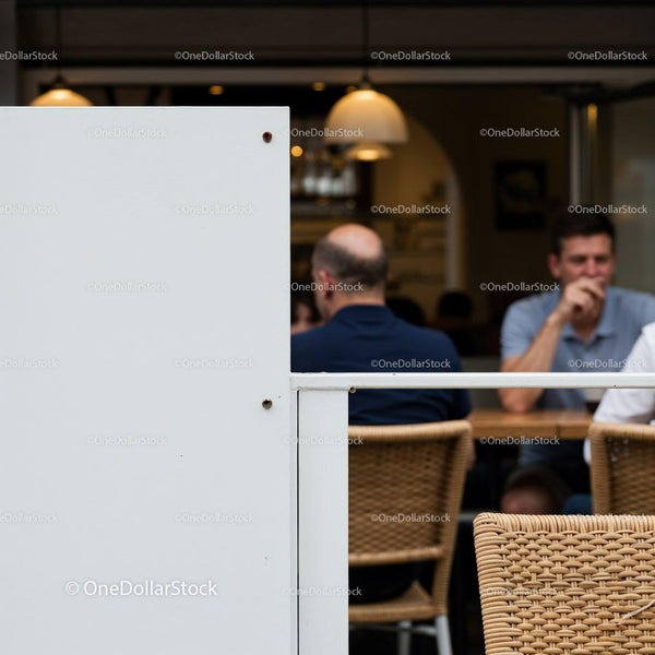 Casual gathering at outdoor cafe with natural wicker chairs JPG Mockup Image