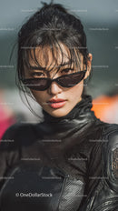 Confident Woman in Sunglasses with a Bold Black Outfit