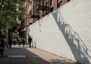 City Sidewalk with Pedestrians and Tree Shadows
