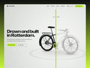 Passer e-bike template hero on light grey drafting paper: a city bike split by a yellow-green scan line into a built half and a line-drawing half, the headline Drawn and built in Rotterdam and a yellow-green Book a test ride button